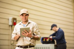 HVAC-technicians-working-on-an-outdoor-unit