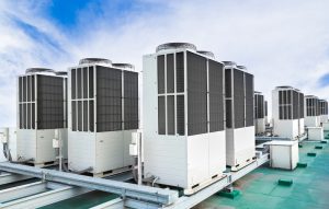 row-of-rooftop-AC-units-against-a-sunny-sky